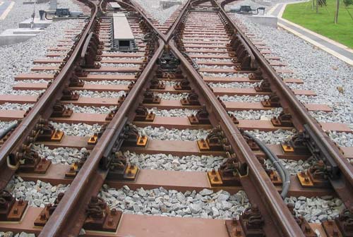 Glass fiber composite sleepers being installed on a railway track