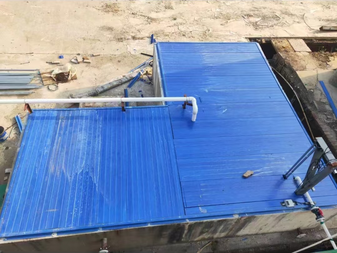 Blue FRP cover plates installed over a rectangular tank