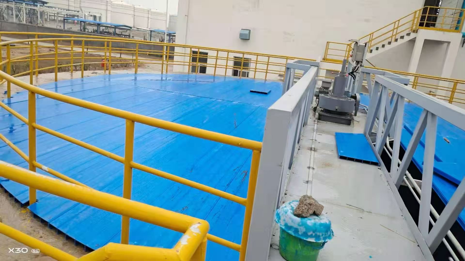 Blue FRP cover plates installed over a circular clarifier tank