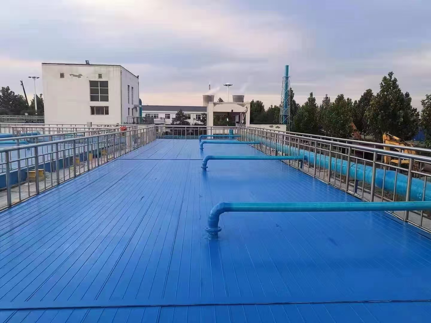 Blue FRP cover plates installed as a walkway at a wastewater treatment plant